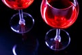 Two Glasses of red wine in night club on black background Royalty Free Stock Photo