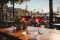 Two glasses of red wine in a restaurant overlooking beautiful mediterranean landscape on sunset. Drinking wine, evening lights,