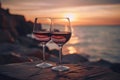 Two glasses of red wine in a restaurant overlooking beautiful mediterranean landscape on sunset. Generative AI Royalty Free Stock Photo