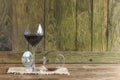 Two glasses of red wine on rustic wooden background.