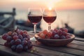 Two glasses of red wine and some grapes in a restaurant overlooking beautiful mediterranean landscape on sunset. Generative AI Royalty Free Stock Photo