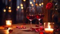 Two glasses of red wine on a wooden restaurant table with candles and red rose petals, Royalty Free Stock Photo