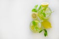 Two glasses of refreshing non alcoholic mojito drink with lemon slices, mint leaves and ice. Studio shot of iced lemonade isolated Royalty Free Stock Photo