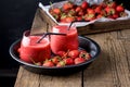 Two Glasses of Refreshing Strawberry Peach Smoothies with Lemon on Black Tray Wooden Background Fresh Strewberry Peach and Lemon Royalty Free Stock Photo