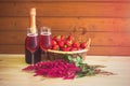 Two glasses of rose champagne, bottle of rose champagne, astilbe flowers and fresh strawberry in wicker basket Royalty Free Stock Photo