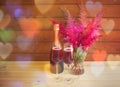 Two glasses of rose champagne, bottle of rose champagne and astilbe flowers on wooden table Royalty Free Stock Photo