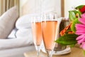 Two glasses of rose champagne in the upscale hotel room. Dating, romance, honeymoon, valentine, getaway, staycation Royalty Free Stock Photo