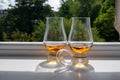 Two glasses of single malt scotch whisky served on old window sill in Scottisch house with view on old part of Edinburgh, Scotland Royalty Free Stock Photo