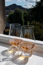 Two glasses of single malt scotch whisky served on old window sill in Scottisch house with view on old part of Edinburgh, Scotland Royalty Free Stock Photo