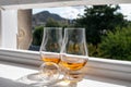 Two glasses of single malt scotch whisky served on old window sill in Scottisch house with view on old part of Edinburgh, Scotland Royalty Free Stock Photo