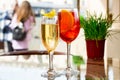 Two glasses of sparkling wine cocktails and Aperol Spritz cocktails on table in terrace of restaurant or summer cafe Royalty Free Stock Photo