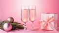 Two glasses of sparkling wine, gift box with bow, decorations. Composition in pink for Christmas, New Year. Still life with drinks Royalty Free Stock Photo