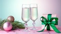 Two glasses of sparkling wine, gift box with bow, decorations. Composition in pink and green for Christmas, New Year Royalty Free Stock Photo