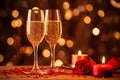 Two glasses of sparkling wine lit candles and red roses on festive glow bokeh background. Valentine day anniversary birthday event