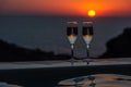 Two glasses of sparkling wine by the pool on a sunset background Royalty Free Stock Photo