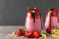 Two glasses of strawberry chia seed pudding with chocolate, fresh berries, granola, elderflowers and mint Royalty Free Stock Photo