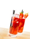 Two glasses of strawberry cocktail with ice on light wood table Royalty Free Stock Photo