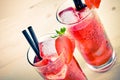 Two glasses of strawberry cocktail with ice on old wood table, old style Royalty Free Stock Photo