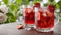 Two glasses of strawberry lemonade on a table