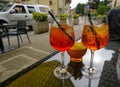 Two glasses of summer cocktail on the table across fried potatoes and city street. Aperitif time. Summertime relax Royalty Free Stock Photo