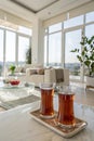 Two glasses of tea on table in bright, modern living room setting, copy space Royalty Free Stock Photo
