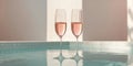 Two glasses toasting rose champagne in clear pool Royalty Free Stock Photo