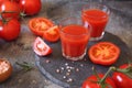 Two glasses of tomato juice, bunch of tomatoes and pink salt Royalty Free Stock Photo