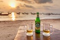 Two glasses of Chang beer on the beach at sunset