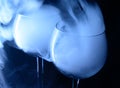 Two glasses with Vodka and martini covered with a white smoke.