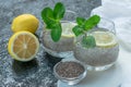 Two glasses of water with chia seeds and lemon on a black background. Slimming drinks concept. Royalty Free Stock Photo