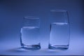 two glasses of water curved back to back Royalty Free Stock Photo