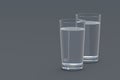Two glasses of water on gray background Royalty Free Stock Photo