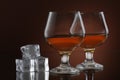 Two glasses of whiskey on brown background