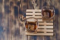 Two Glasses of whiskey with ice cubes on a wooden table/Two Glasses of cognac with ice cubes on a wooden table. Top view, Royalty Free Stock Photo