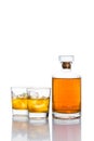 Two glasses of whiskey on the rocks, with a whiskey bottle in white background Royalty Free Stock Photo