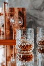 Two glasses of whiskey stand on a mirrored bar counter Royalty Free Stock Photo