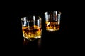 Two glasses of whiskey or whisky with ice on black background. Royalty Free Stock Photo