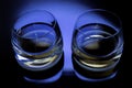 Two glasses whisky black background blue light Royalty Free Stock Photo