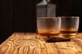 Two glasses of whisky and cigars on wooden table Royalty Free Stock Photo