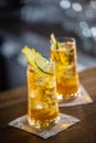 Two glasses of whisky and ginger lemonade with ice and slices of fresh ginger and lime Royalty Free Stock Photo