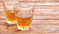 Two glasses of whisky on wooden background. Space for text Royalty Free Stock Photo