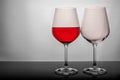 Two glasses on a white background, one glass half full the second empty Royalty Free Stock Photo