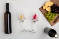 Two glasses of white and red wine, cheese and grapes. Top view Royalty Free Stock Photo
