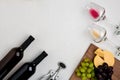 Two glasses of white and red wine, cheese and grapes. Top view Royalty Free Stock Photo