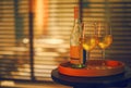 Two glasses of white wine and bottle in the restaurant on blurred background Royalty Free Stock Photo