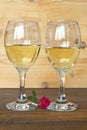 Two glasses of white wine and a rose Royalty Free Stock Photo