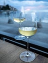 Two glasses of white wine with sunset over sea on background. Royalty Free Stock Photo