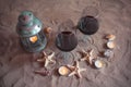 Two glasses of wine, candles, lantern, shells, starfishes. Royalty Free Stock Photo