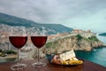 Two glasses of wine with charcuterie assortment against view of Dubrovnik, Croatia. Glass of red wine with different snacks - Royalty Free Stock Photo