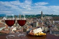 Two glasses of wine with cheese and meat snacks with view from above of Florence historic city center in Italy. Glass of red wine Royalty Free Stock Photo